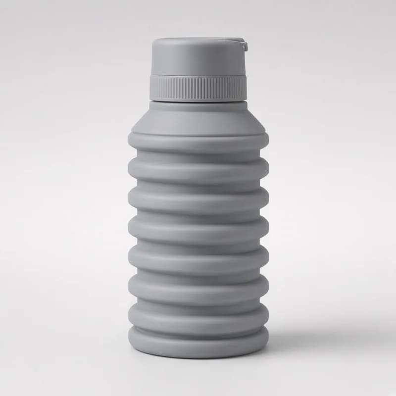 Reference photo of a partly compressed collapsible silicone bottle