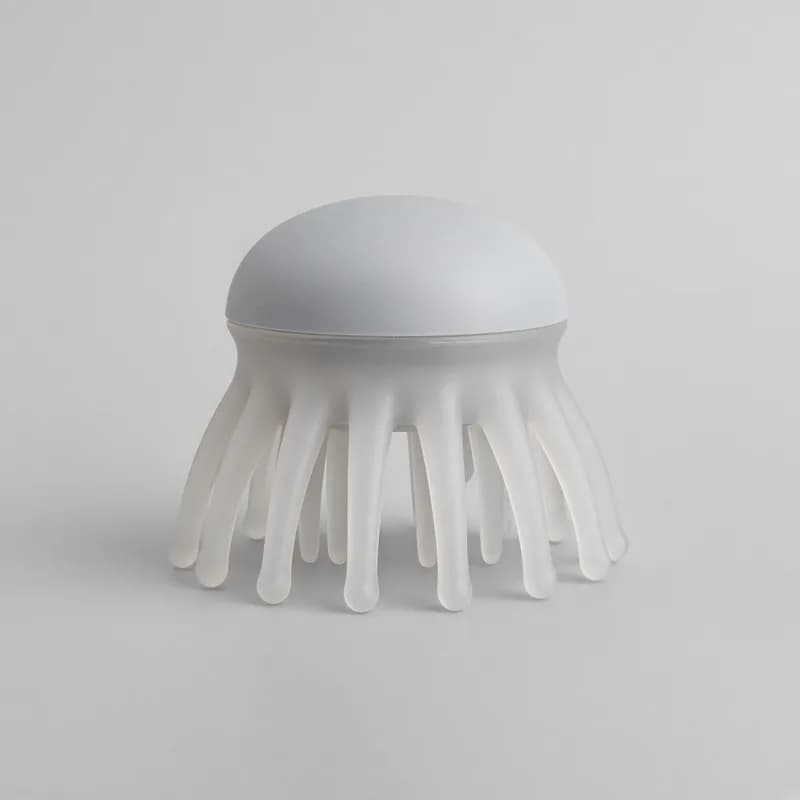 Reference photo of a manual scalp massager with flexible silicone fingers
