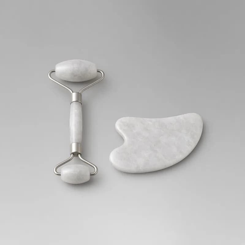 Reference photo of a stone facial roller and a flat gua sha tool